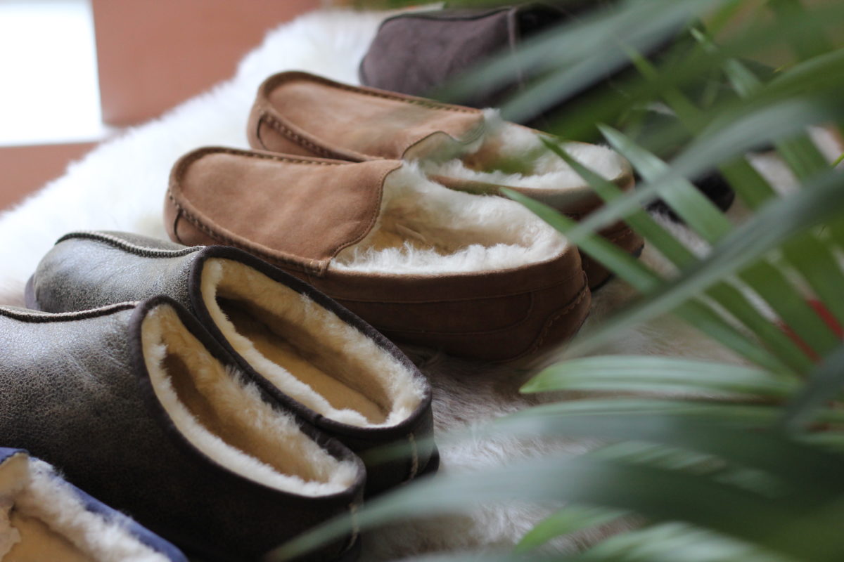 A line of men's moccasin slippers and men's mule slippers in chestnut and brown for a Father's Day gift guide